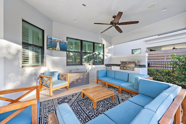 view of patio featuring grilling area, ceiling fan, exterior kitchen, and an outdoor hangout area