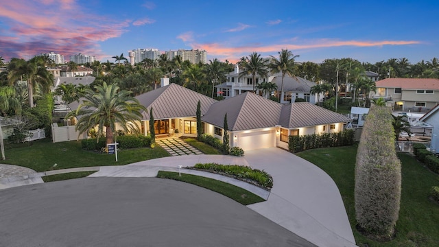 view of front of property featuring a yard and a garage