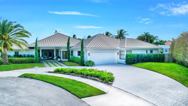 view of front of house with a garage and a front yard