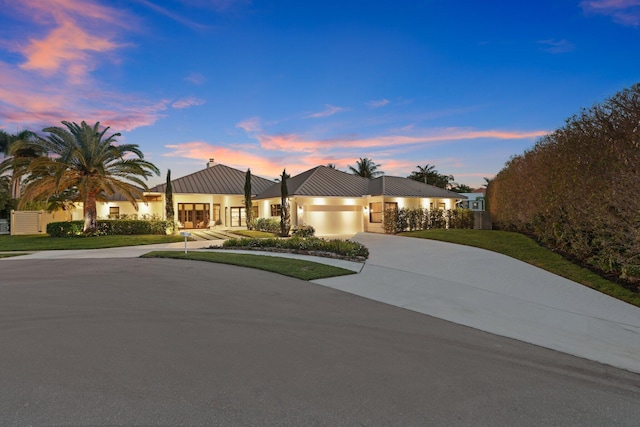 view of front of home featuring a yard and a garage