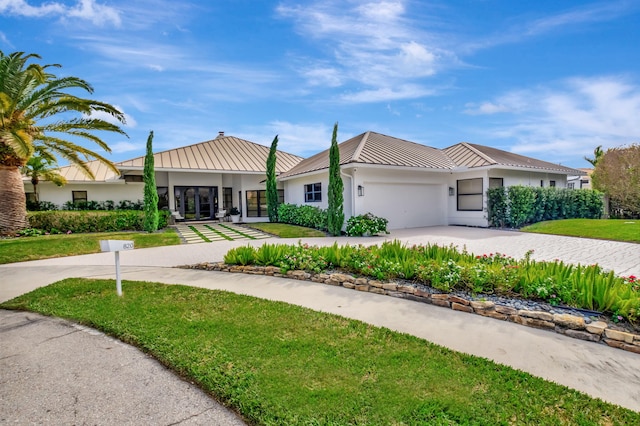 view of front of property with a garage and a front lawn