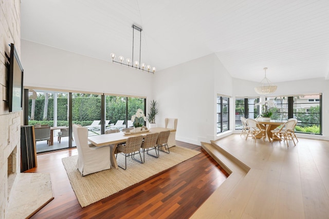 dining space featuring a chandelier, a high ceiling, and light wood-type flooring