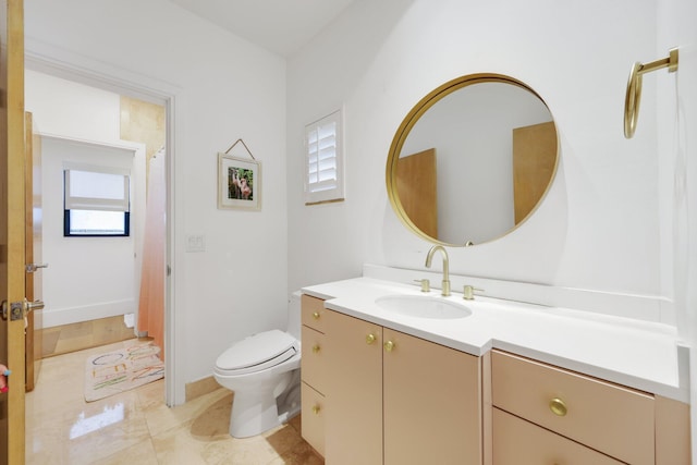 bathroom featuring vanity and toilet