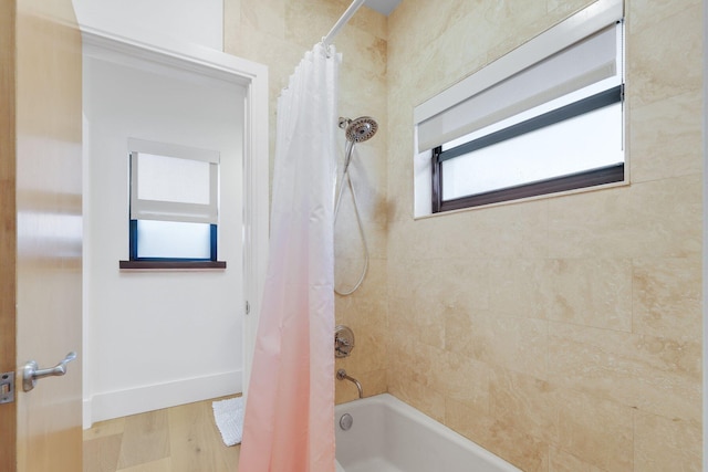 bathroom featuring hardwood / wood-style flooring and shower / bath combo with shower curtain