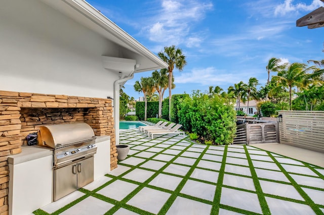 view of patio with exterior kitchen and grilling area