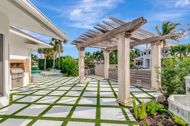 view of patio / terrace with exterior kitchen, a grill, and a pergola