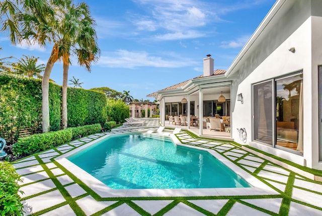 view of swimming pool with a patio area