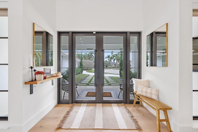 doorway with light hardwood / wood-style floors and french doors