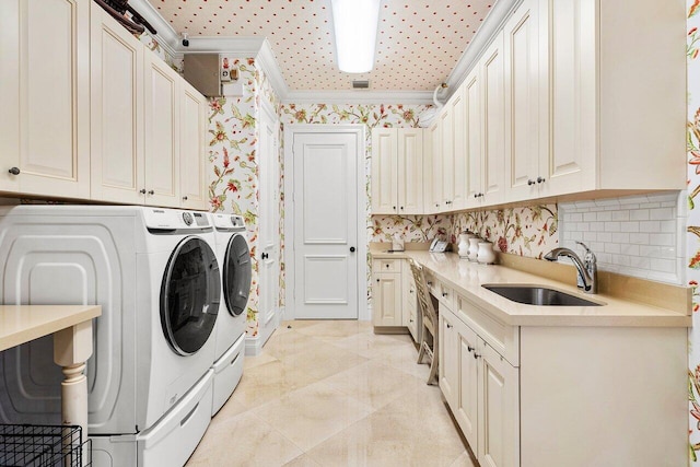 laundry room with crown molding, cabinets, separate washer and dryer, and sink