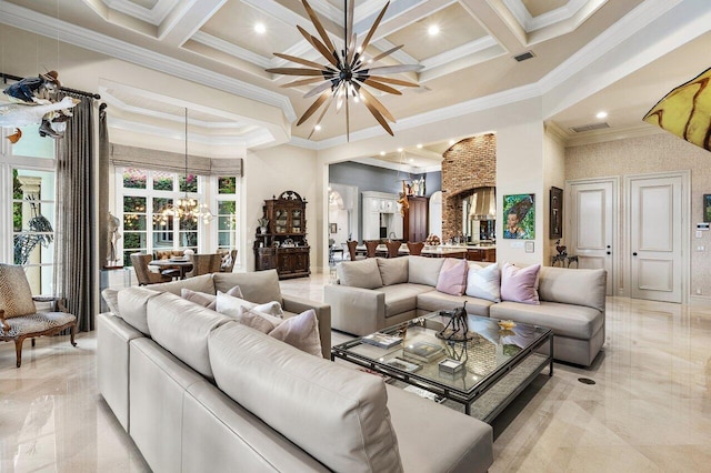 living area with marble finish floor, coffered ceiling, a high ceiling, and an inviting chandelier