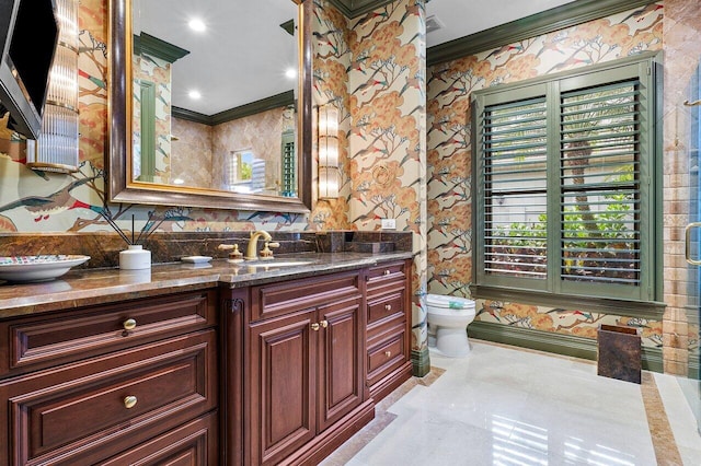 full bathroom with toilet, wallpapered walls, ornamental molding, and vanity