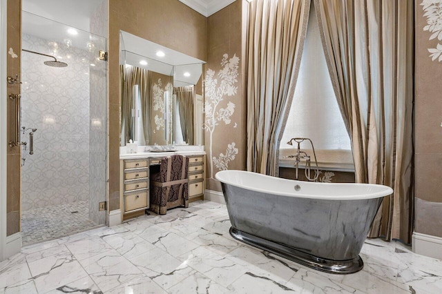 full bath with a freestanding bath, marble finish floor, a shower stall, and vanity