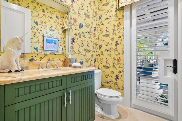 bathroom with a wealth of natural light, vanity, ornamental molding, and toilet