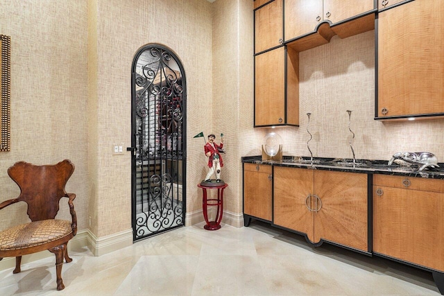 interior space with baseboards and light tile patterned floors