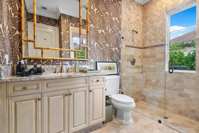 bathroom featuring crown molding, toilet, vanity, and walk in shower