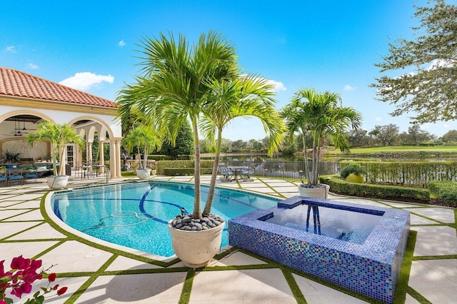 view of swimming pool featuring a water view and a patio area