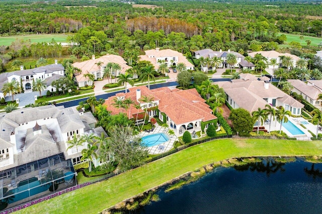 birds eye view of property featuring a residential view, a water view, and a view of trees