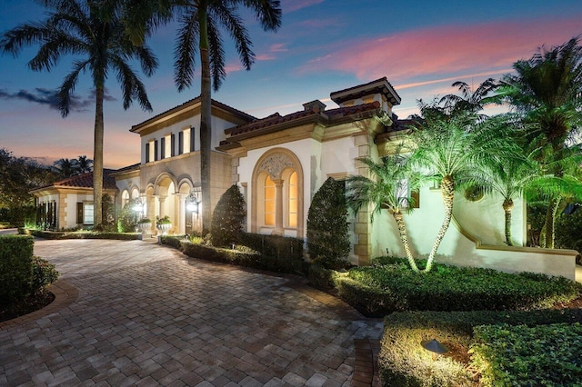 mediterranean / spanish-style house with driveway and stucco siding