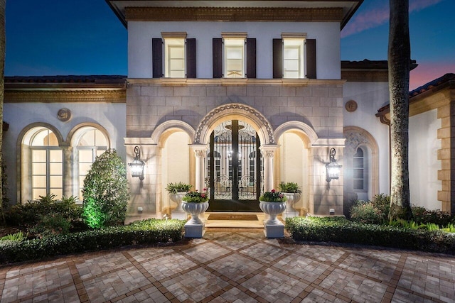 entrance to property with stucco siding and french doors