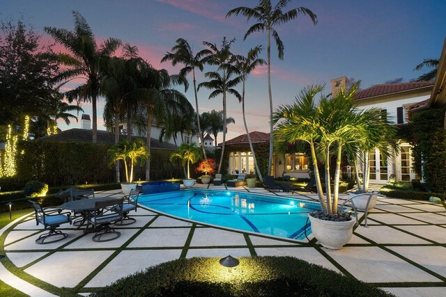 exterior entry at dusk featuring french doors