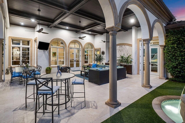 view of patio / terrace with outdoor dining space, outdoor lounge area, a ceiling fan, and french doors