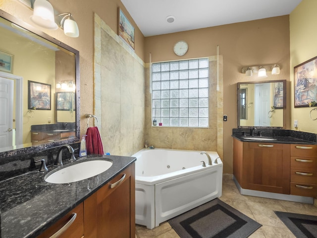 bathroom featuring tile patterned flooring, vanity, and a bath