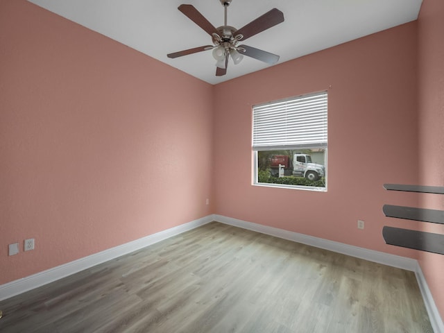 empty room featuring ceiling fan and light hardwood / wood-style floors