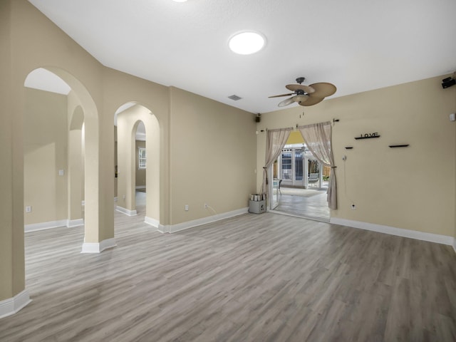 empty room with light hardwood / wood-style flooring and ceiling fan