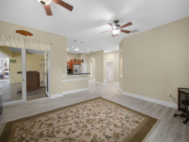 living room with ceiling fan and light hardwood / wood-style floors