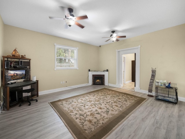 living room with hardwood / wood-style flooring and ceiling fan