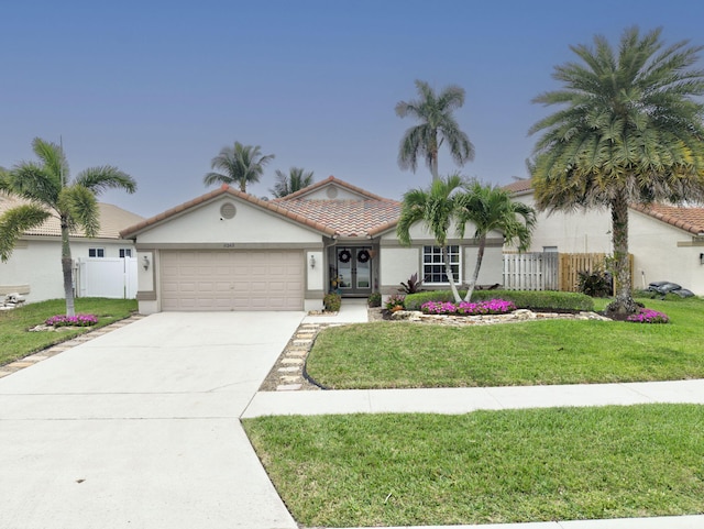 view of front of home with a front yard and a garage