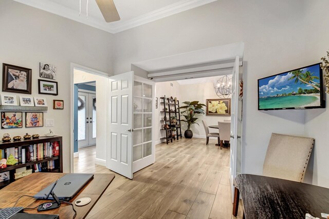 interior space with french doors, ceiling fan with notable chandelier, light hardwood / wood-style floors, and crown molding