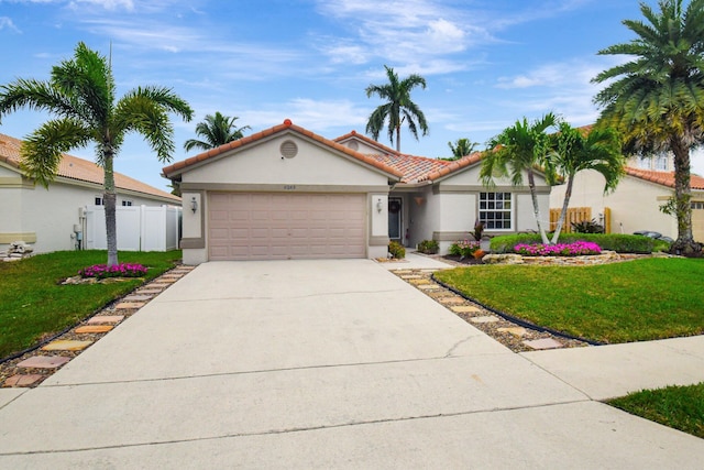 view of front of home featuring a front yard and a garage