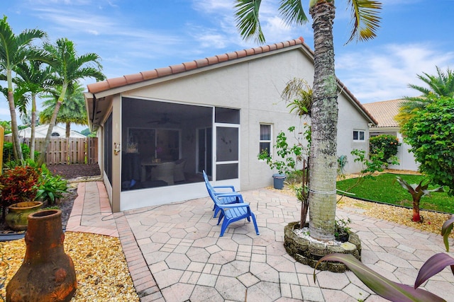 back of house featuring a sunroom and a patio