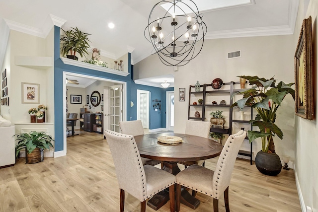 dining area with vaulted ceiling, light hardwood / wood-style flooring, and ornamental molding