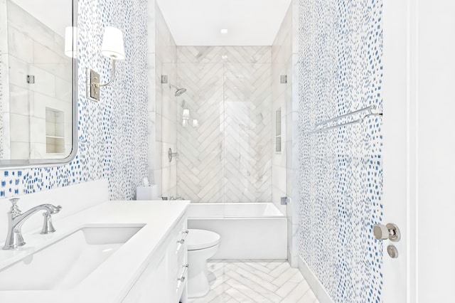 full bathroom featuring tile patterned flooring, vanity, toilet, and tiled shower / bath