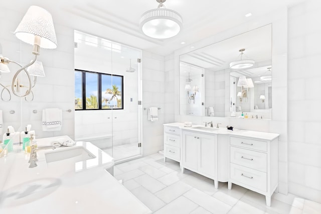 bathroom with tile patterned flooring, vanity, an enclosed shower, and tile walls