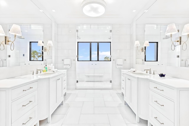 bathroom featuring vanity, an enclosed shower, and tile walls