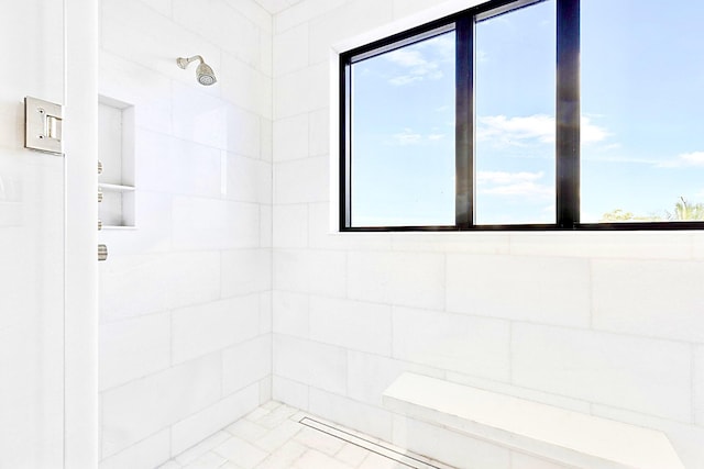 bathroom with tiled shower