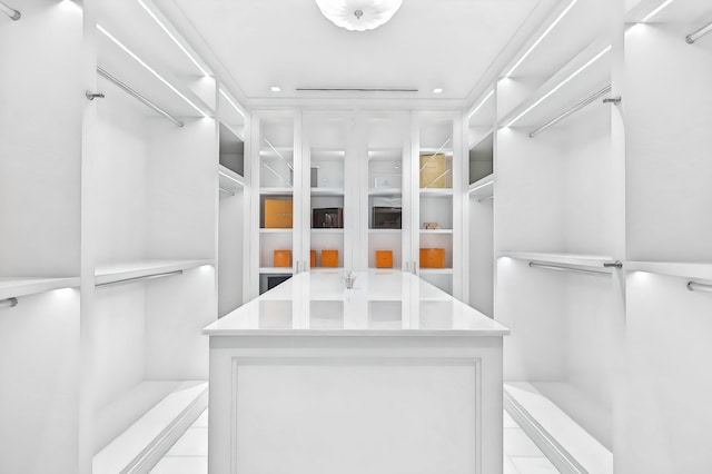 walk in closet with light tile patterned floors