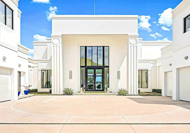 back of property with a garage