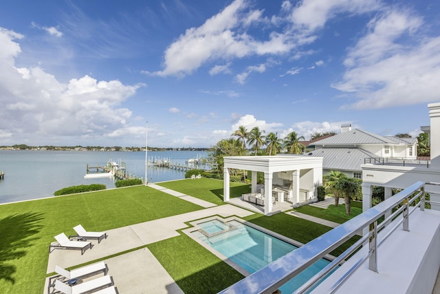 balcony with exterior bar, a patio, a water view, and an in ground hot tub