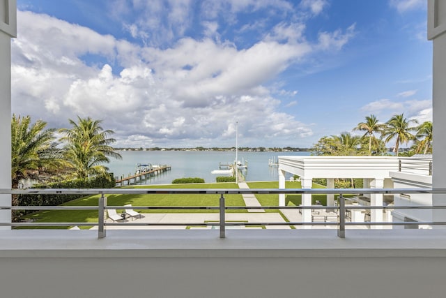 balcony with a water view and a boat dock