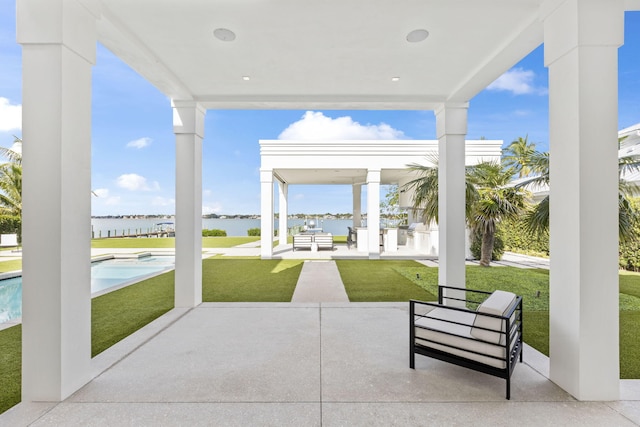 view of patio / terrace with an outdoor living space and a water view