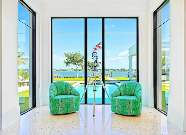 doorway with a water view and a wealth of natural light