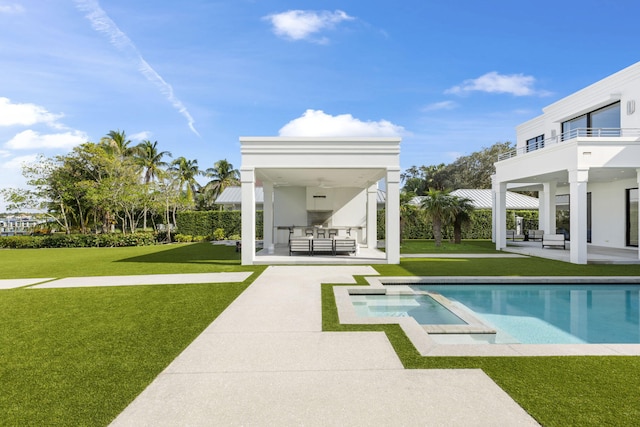 rear view of house featuring a balcony, a patio area, and a lawn