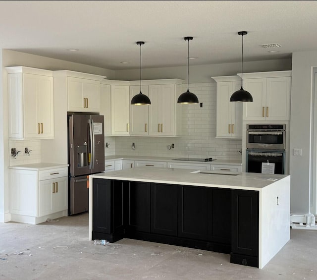 kitchen with appliances with stainless steel finishes, white cabinetry, decorative backsplash, hanging light fixtures, and a center island