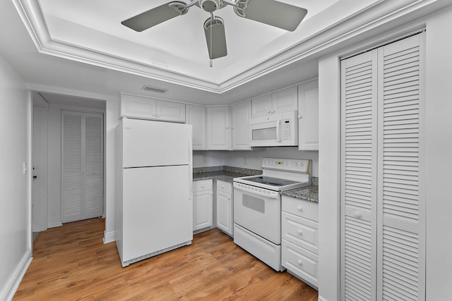 kitchen with white cabinetry, ceiling fan, white appliances, a tray ceiling, and light wood-type flooring