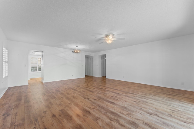 unfurnished living room with ceiling fan, a textured ceiling, and light wood-type flooring