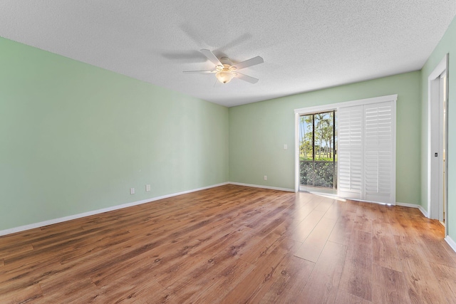 spare room with ceiling fan, light hardwood / wood-style flooring, and a textured ceiling